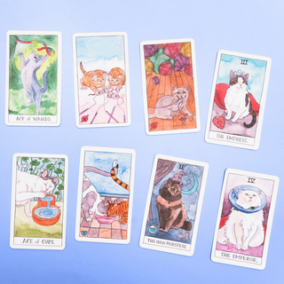 Set of tarot cards with cat illustrations on a blue background