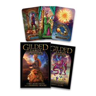 Gilded Tarot cards with their packaging on a white background