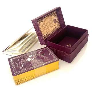 Purple and gold card deck with an open box on a white background
