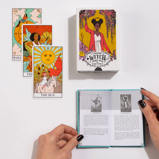 Tarot cards and book with colorful illustrations on a white background