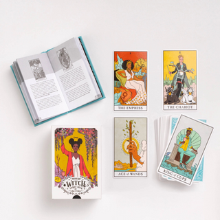 Set of tarot cards with an open book on a white background
