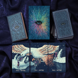 Collection of tarot cards with artistic designs on a dark fabric background