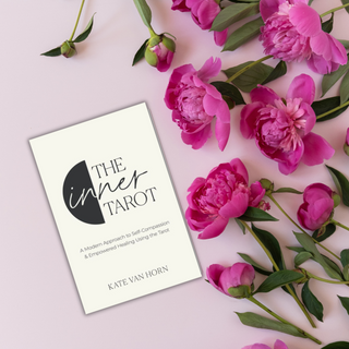 Book titled 'The Inner Tarot' by Kate Van Horn surrounded by pink flowers on a light pink background