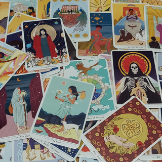 Collection of colorful tarot cards with various designs and characters.